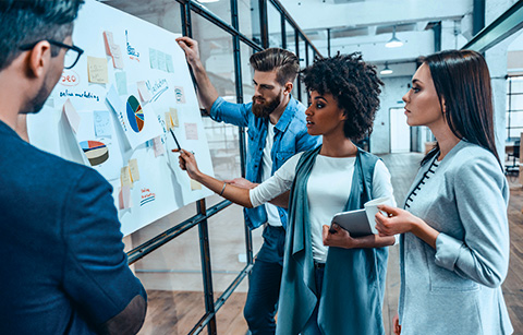 A group of diverse people planning in a business setting.